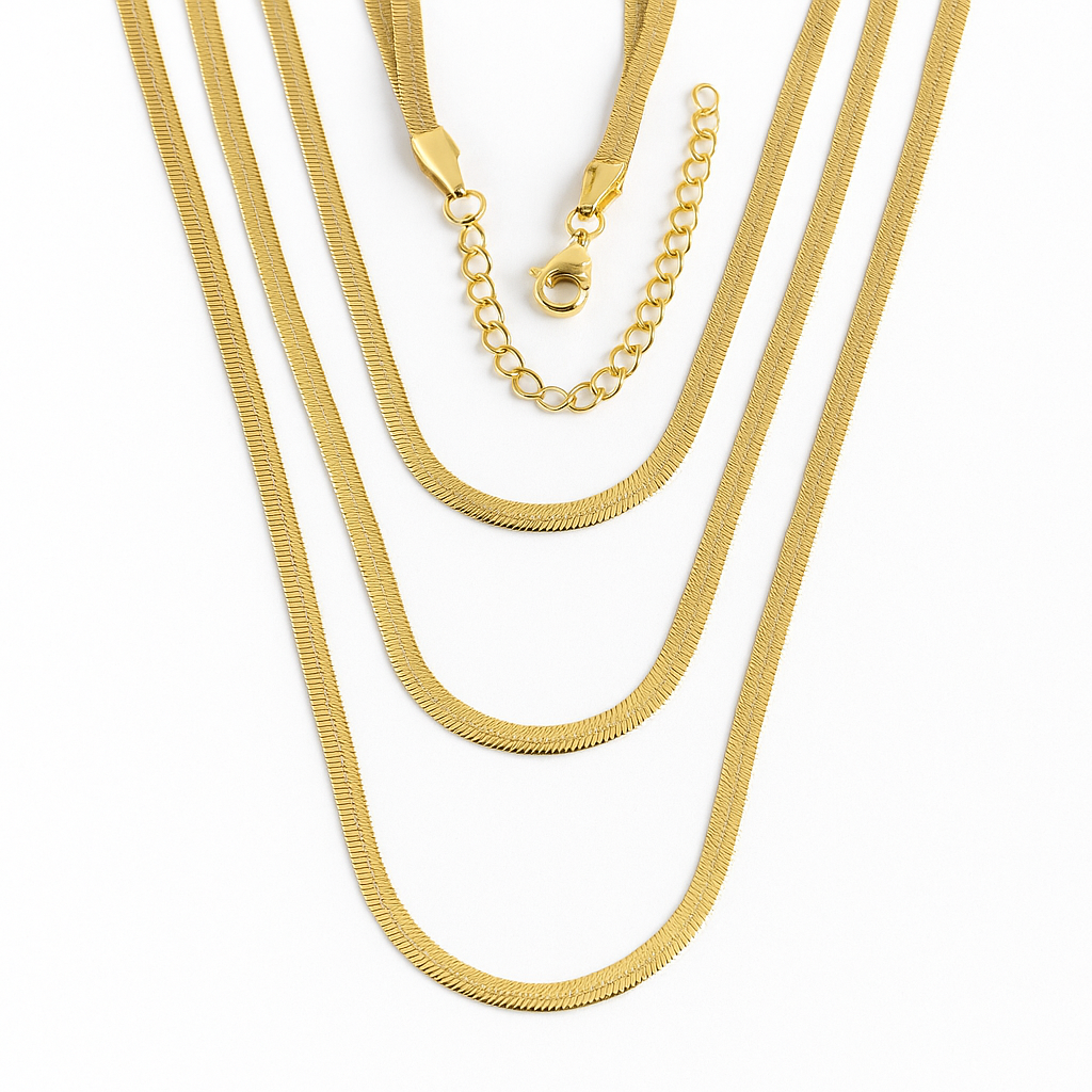 Three gold necklaces of different styles on a white background