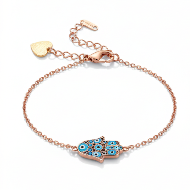 Rose gold bracelet with a blue and green evil eye charm on a white background
