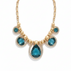 Gold necklace with blue teardrop-shaped stones on a white background