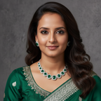 Woman wearing a green saree with silver border and jewelry against a gray background