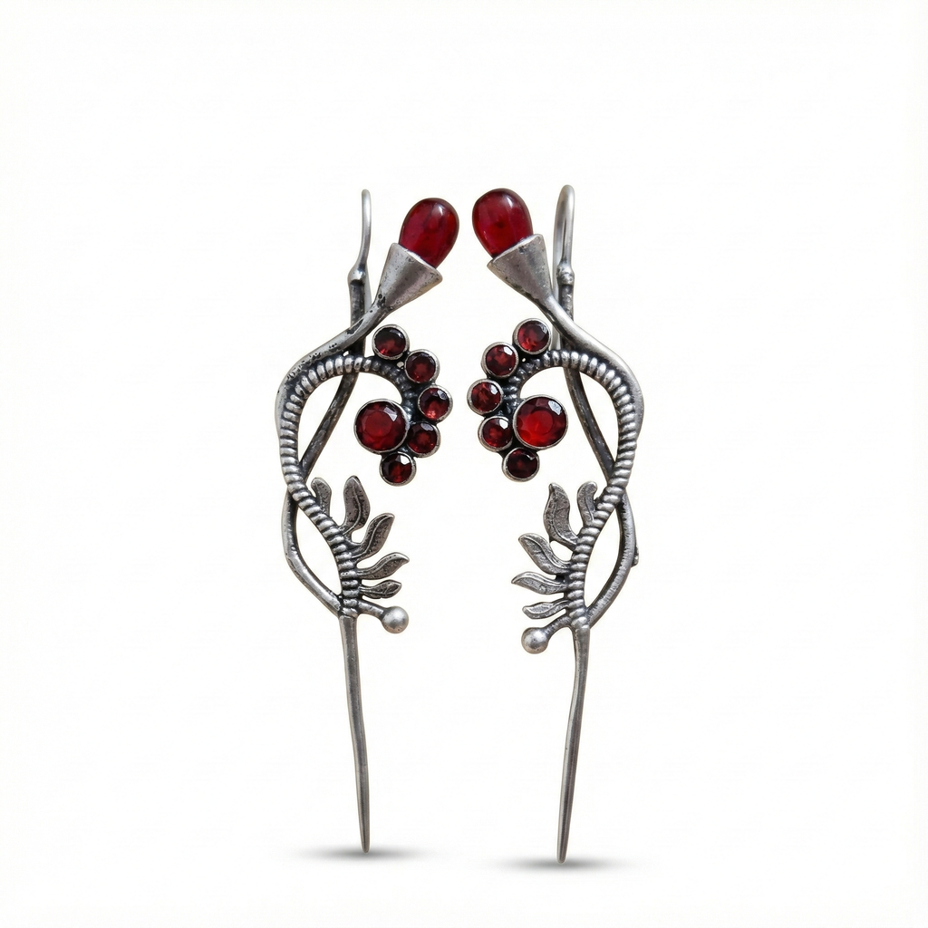 Silver hairpins with red gemstones on a white background