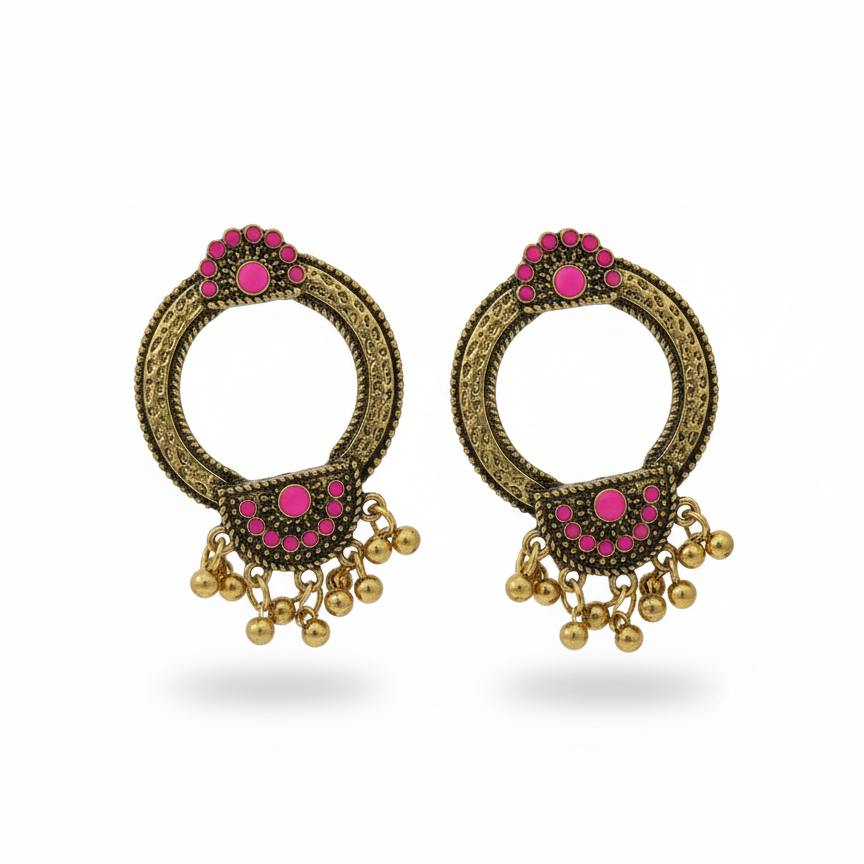Pair of ornate earrings with pink gemstones and gold accents on a white background