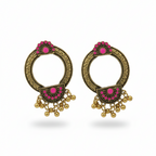 Pair of ornate earrings with pink gemstones and gold accents on a white background