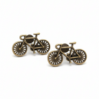 Bronze bicycle-shaped cufflinks on a white background