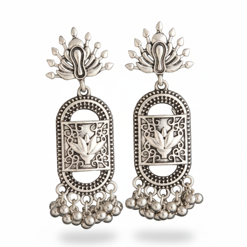 Pair of silver earrings with intricate designs on a white background