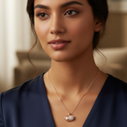 Woman wearing a blue dress with a necklace in an indoor setting