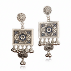 Pair of ornate earrings with floral designs and dangling beads on a white background