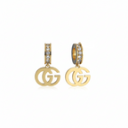 Gold earrings with 'GG' logo on a white background