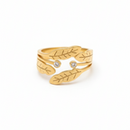 Gold ring with leaf design on a white background