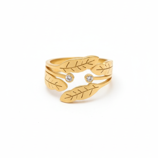 Gold ring with leaf design on a white background