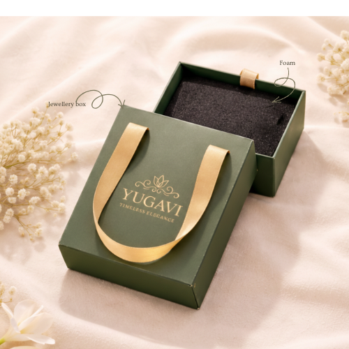 Green jewelry box with gold handle and 'Yugavi' branding on a soft beige background.